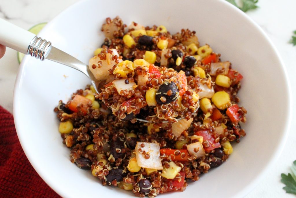 Spoonful of southwest quinoa salad, with black beans, corn and veggies.